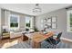 Bright office space featuring a large desk, comfortable seating, hardwood floors, and lots of natural light at 1035 Zelkova Ln, Chapel Hill, NC 27517