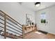 Welcoming entryway with wood floors, decorative table, and modern staircase at 1035 Zelkova Ln, Chapel Hill, NC 27517