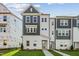 New two-story home featuring gray and white accents, situated on a neatly manicured lawn at 1035 Zelkova Ln, Chapel Hill, NC 27517