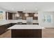 Modern kitchen featuring stainless steel appliances, granite countertops, and stylish pendant lighting at 1035 Zelkova Ln, Chapel Hill, NC 27517