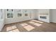 Bright living room with hardwood floors, a fireplace, and multiple large windows at 1035 Zelkova Ln, Chapel Hill, NC 27517