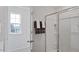 Bathroom with glass enclosed shower, towel rack with stacked towels, and a window view at 106 Craig Point Dr, Clayton, NC 27520