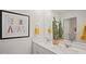 Bathroom with double sink vanity, decorative mirror, and cheerful artwork at 106 Craig Point Dr, Clayton, NC 27520