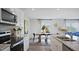Modern dining room featuring stainless steel appliances, a granite island, and sleek hardwood floors at 106 Craig Point Dr, Clayton, NC 27520