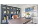 Stunning home office design with stylish blue bookcase, statement desk, and bright natural light at 106 Craig Point Dr, Clayton, NC 27520