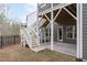 The home's backyard features a patio area and stairs leading to a second-story porch at 116 Pointe Park Cir, Holly Springs, NC 27540