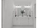 Bright bathroom featuring dual sinks, marble countertops, and modern fixtures at 116 Pointe Park Cir, Holly Springs, NC 27540