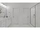 Bright bathroom with a marble-top vanity, glass shower, and white tile flooring at 116 Pointe Park Cir, Holly Springs, NC 27540