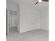 Bright bedroom featuring neutral paint, comfortable carpeting, and a view into the hall through an open doorway at 116 Pointe Park Cir, Holly Springs, NC 27540