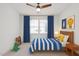Cozy bedroom with blue curtains, fun artwork, and a teddy bear pillow, creating a playful retreat at 116 Pointe Park Cir, Holly Springs, NC 27540