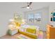 Bright bedroom with a stylish yellow bed, colorful rug, and ample natural light from the window at 116 Pointe Park Cir, Holly Springs, NC 27540