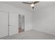 Bedroom boasts neutral carpet, white walls and trim, ceiling fan, and closet with sliding doors at 116 Pointe Park Cir, Holly Springs, NC 27540