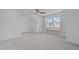Bonus room featuring neutral carpet, vaulted ceilings, and built-in shelves surrounding the large window at 116 Pointe Park Cir, Holly Springs, NC 27540