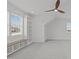 Spacious bonus room features custom built-in shelves, window seat, and neutral color carpet at 116 Pointe Park Cir, Holly Springs, NC 27540