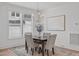 Elegant dining area with a modern chandelier, white walls, and a table setting for four in natural light at 116 Pointe Park Cir, Holly Springs, NC 27540