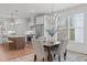Cozy dining room area with a wooden table set and a chandelier near bright windows at 116 Pointe Park Cir, Holly Springs, NC 27540