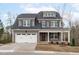Charming two-story home featuring a gray exterior, white trim, covered porch, and a two-car garage at 116 Pointe Park Cir, Holly Springs, NC 27540