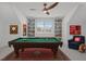 A game room featuring a pool table, built-in shelves, and a cozy seating area with decorative sports memorabilia at 116 Pointe Park Cir, Holly Springs, NC 27540