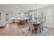 Open-concept kitchen with stainless steel appliances, an island with bar stools, and an adjacent dining area at 116 Pointe Park Cir, Holly Springs, NC 27540