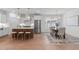 Bright kitchen with white cabinets, stainless steel appliances, kitchen island, and adjacent dining area at 116 Pointe Park Cir, Holly Springs, NC 27540