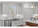 Bright kitchen with stainless steel appliances, white cabinetry, and a stainless steel sink at 116 Pointe Park Cir, Holly Springs, NC 27540