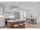 View of kitchen with an island, stainless steel appliances, and adjacent dining area at 116 Pointe Park Cir, Holly Springs, NC 27540
