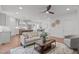 Open-concept living room showcasing a cozy seating area that flows into the dining space at 116 Pointe Park Cir, Holly Springs, NC 27540