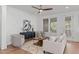 Bright living room featuring modern ceiling fan, stylish furniture and a decorative accent wall at 116 Pointe Park Cir, Holly Springs, NC 27540