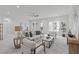 Inviting living room features neutral décor, ample seating, and windows overlooking the outdoors at 116 Pointe Park Cir, Holly Springs, NC 27540