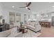 Open-concept living room with a modern ceiling fan and hardwood floors that lead to the kitchen at 116 Pointe Park Cir, Holly Springs, NC 27540