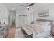 Inviting main bedroom featuring wood accents, a comfortable bed, and an attached sliding barn door at 116 Pointe Park Cir, Holly Springs, NC 27540