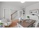 Inviting office featuring a rustic desk, white chair, and a staircase view with natural light at 116 Pointe Park Cir, Holly Springs, NC 27540