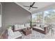 Cozy screened porch with comfortable seating, ceiling fan, and views of the surrounding landscape at 116 Pointe Park Cir, Holly Springs, NC 27540