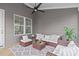 Covered porch featuring comfortable seating, overhead fan, and screened views of the outdoors at 116 Pointe Park Cir, Holly Springs, NC 27540