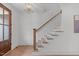Bright foyer staircase features hardwood treads, white risers, and a wooden handrail for a classic design at 116 Pointe Park Cir, Holly Springs, NC 27540