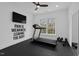Well-equipped workout room with motivational decor, a treadmill, weights, and a mirrored wall at 116 Pointe Park Cir, Holly Springs, NC 27540