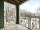 Balcony overlooking parking lot with wooden decking and white railings at 1210 Westview Ln # 201, Raleigh, NC 27605