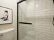 Bathroom shower featuring white subway tile, black accents, and a clear glass shower door at 1210 Westview Ln # 201, Raleigh, NC 27605