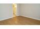 Bedroom features hardwood floors, neutral walls, and a view into the en suite bathroom at 1210 Westview Ln # 201, Raleigh, NC 27605