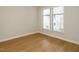 Well-lit bedroom with neutral walls, hardwood floors, and windows with blinds at 1210 Westview Ln # 201, Raleigh, NC 27605