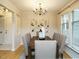 Cozy dining area with seating for six, a decorative chandelier, and natural light at 1210 Westview Ln # 201, Raleigh, NC 27605