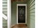 Apartment front door featuring a welcome mat and black hardware at 1210 Westview Ln # 201, Raleigh, NC 27605