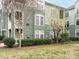 Exterior view of building featuring professionally landscaped lawn and beautiful green siding at 1210 Westview Ln # 201, Raleigh, NC 27605