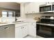 Bright kitchen with stainless steel appliances and white cabinets and countertops at 1210 Westview Ln # 201, Raleigh, NC 27605