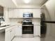 Modern kitchen featuring stainless steel appliances, white cabinets, and marble countertops at 1210 Westview Ln # 201, Raleigh, NC 27605