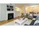 Elegant living room with hardwood floors, modern fireplace, and view into dining room at 1210 Westview Ln # 201, Raleigh, NC 27605