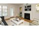 Inviting living room boasting fireplace, hardwood flooring, and natural light from multiple windows at 1210 Westview Ln # 201, Raleigh, NC 27605