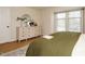 Relaxing main bedroom featuring a dresser with vanity mirror and a cozy bed with a view at 1210 Westview Ln # 201, Raleigh, NC 27605