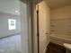 Bathroom adjacent to a bedroom featuring a tub shower combo at 128 Oat Grain Ct, Clayton, NC 27520