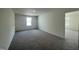 This bedroom has neutral walls, a plush gray carpet, and a doorway to another room with the same features at 128 Oat Grain Ct, Clayton, NC 27520